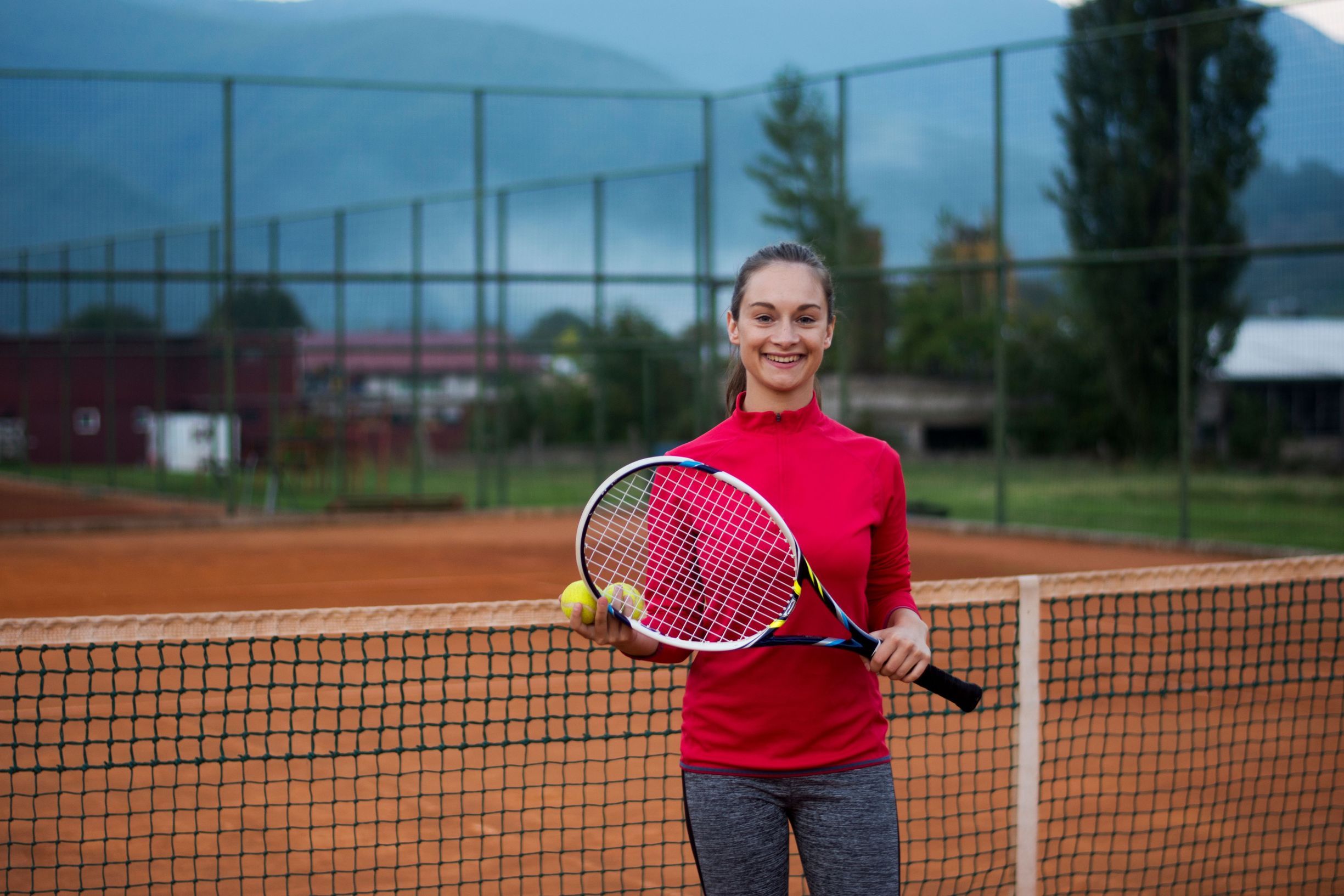 Beautiful female tennis player with tennis racket